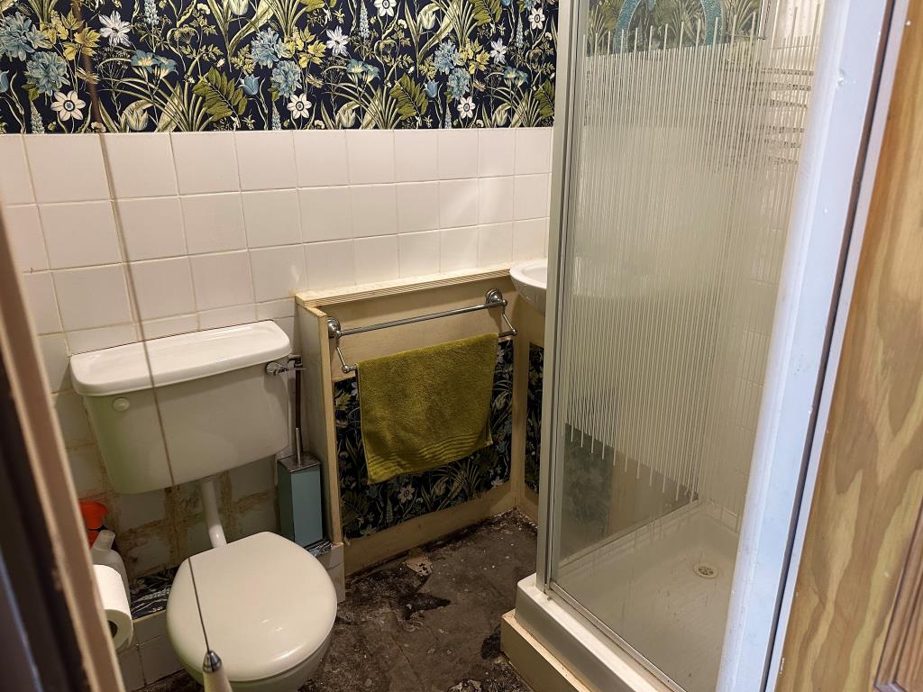 Lot: 145 - ONE-BEDROOM GARDEN FLAT FOR IMPROVEMENT - Bathroom with stand up shower, WC and basin